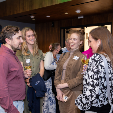 A group of alumni mingling at a global event in San Francisco.